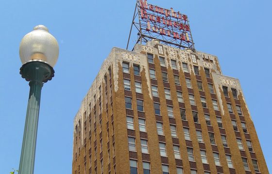 An art-deco tower in downtown Memphis against a clear sky