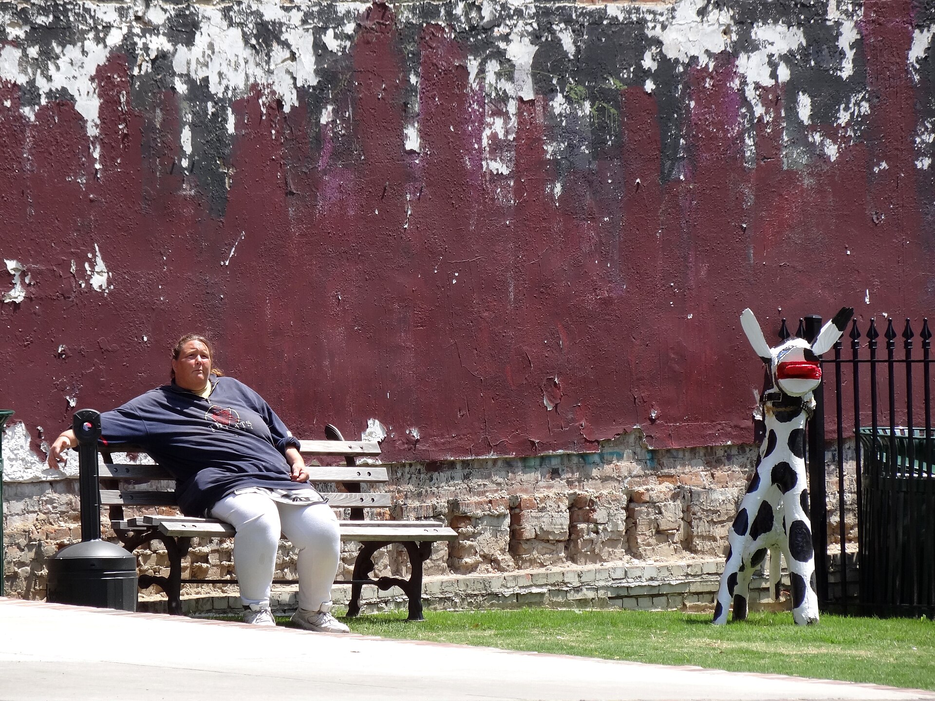 Park scene with a woman and a cow sculpture in downtown Memphis, Tennessee