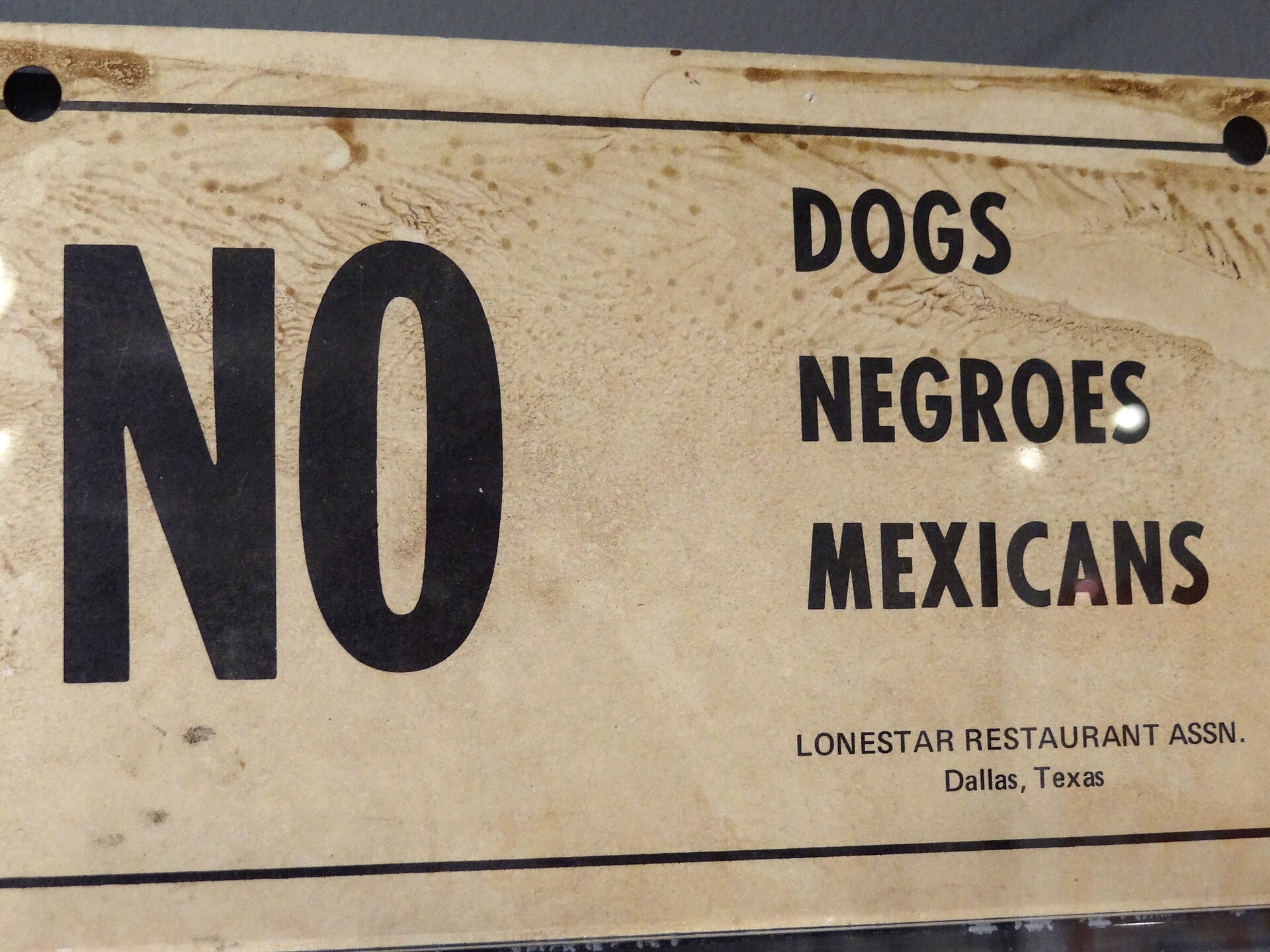 A segregation-era sign reading "No Dogs, Negroes, Mexicans" at the National Civil Rights Museum in Memphis
