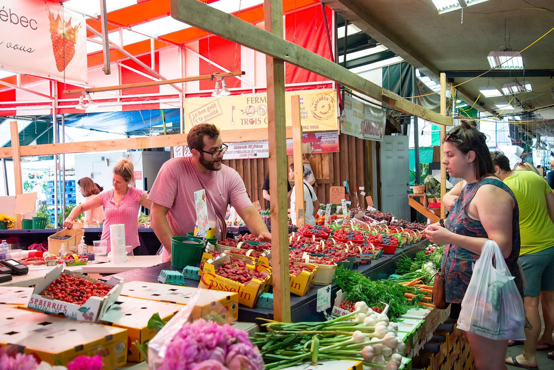 Bustling farmers market with fresh fruits, vegetables and people exploring vibrant stalls