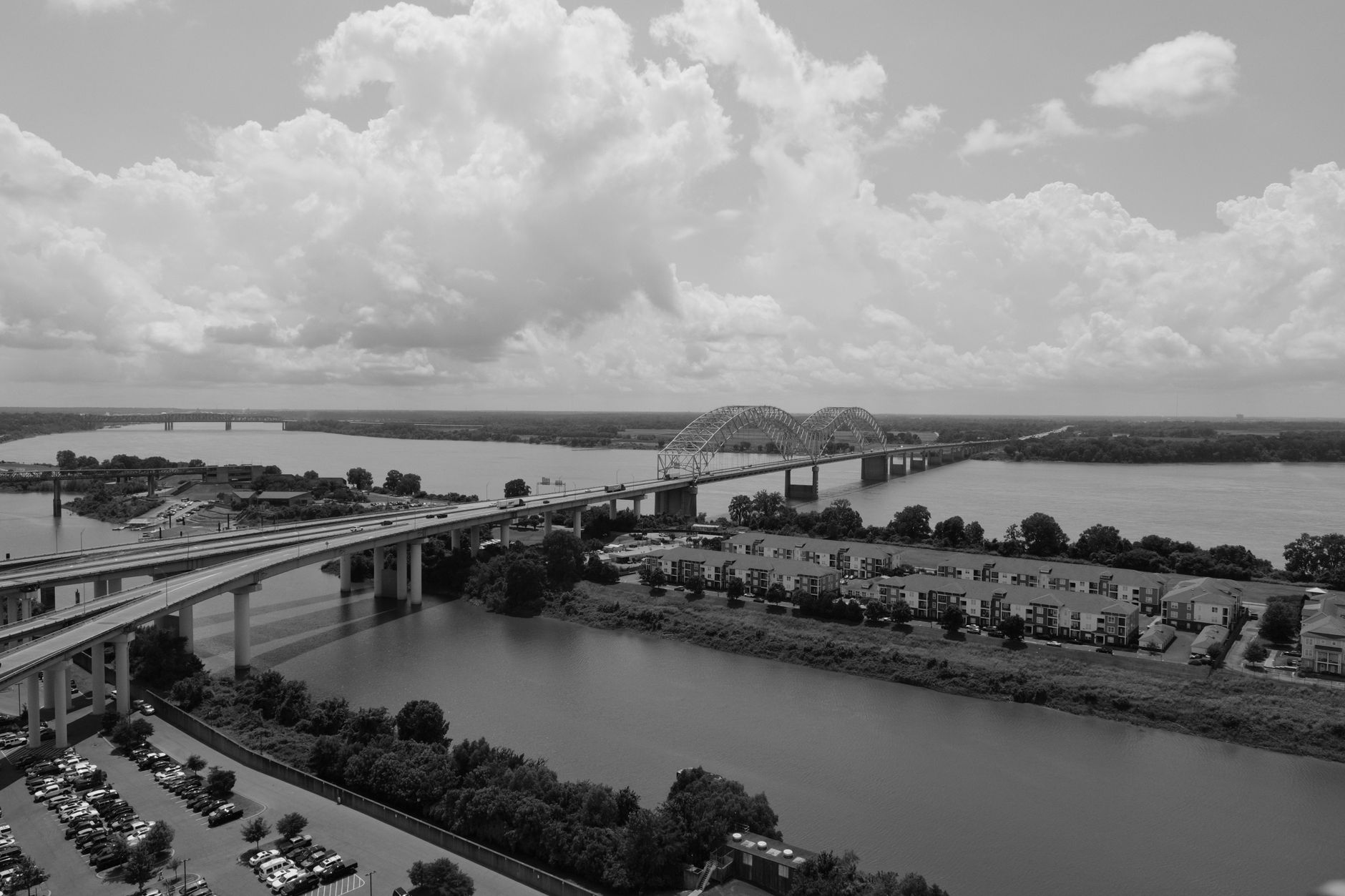 Aerial view of the Hernando de Soto Bridge in Memphis, Tennessee, against a backdrop of clouds